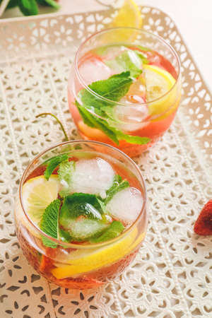 Glasses of fresh strawberry mojito on light trayの写真素材