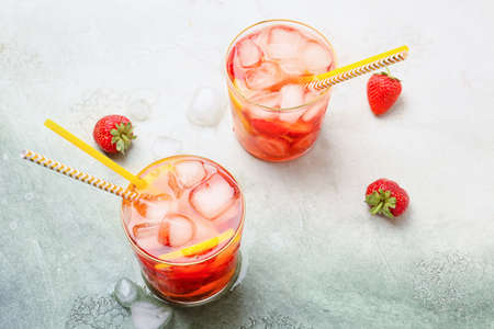 Glasses of fresh strawberry mojito cocktail on tableの写真素材