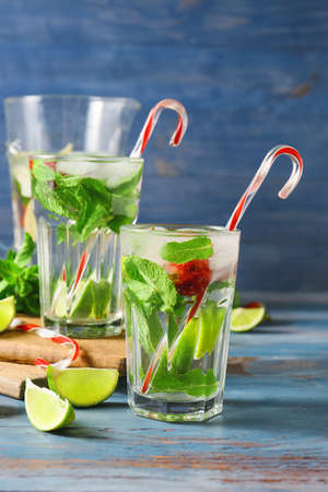 Glasses of fresh strawberry mojito on color backgroundの写真素材