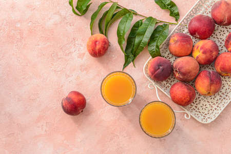 Glasses of tasty peach juice on color background