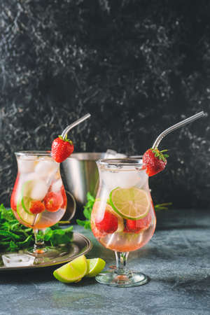 Glasses of tasty strawberry mojito cocktail on tableの写真素材