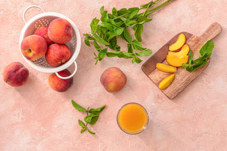 Glass of tasty peach juice on color backgroundの写真素材