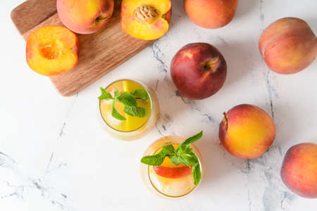 Glasses of tasty peach juice on white backgroundの写真素材