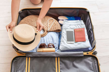 Woman packing suitcase at home. Travel conceptの写真素材