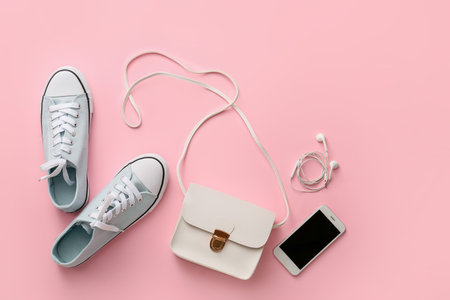 Stylish bag, mobile phone and shoes on color backgroundの写真素材