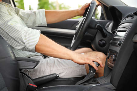Handsome man driving modern car