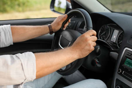 Handsome man driving modern car