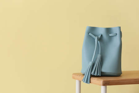Stylish bag on table against color backgroundの写真素材