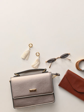 Stylish bag and accessories on light background