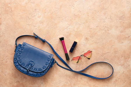 Stylish bag and cosmetics on color backgroundの写真素材