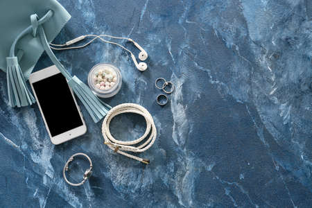 Stylish bag, accessories and mobile phone on color backgroundの写真素材