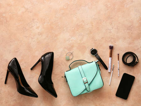 Stylish bag, accessories and mobile phone on color backgroundの写真素材