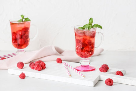 Cups of cold raspberry tea on tableの写真素材