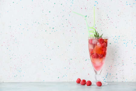 Glass of cold raspberry tea on tableの写真素材