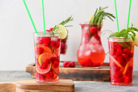 Glasses of cold raspberry tea on tableの写真素材