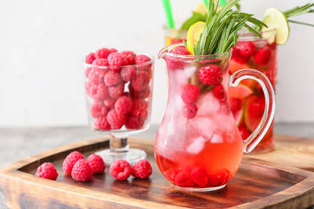 Jug of cold raspberry tea on tableの写真素材