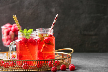 Mason jars of cold raspberry tea on dark backgroundの写真素材