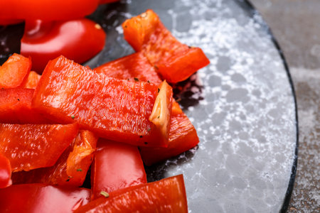 Sliced red bell pepper on dark tableの写真素材