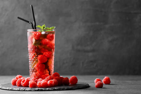 Glass of cold raspberry tea on dark backgroundの写真素材