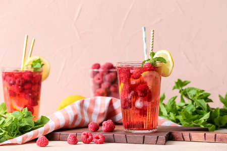Glass of cold raspberry tea on tableの写真素材
