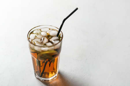 Glass of tasty Cuba Libre cocktail on tableの写真素材