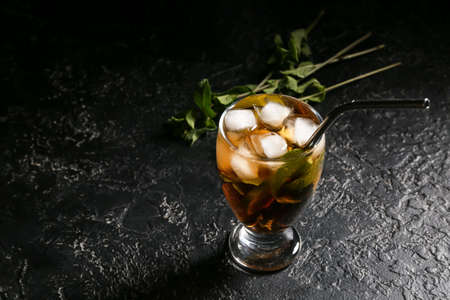Glass of tasty Cuba Libre cocktail on tableの写真素材