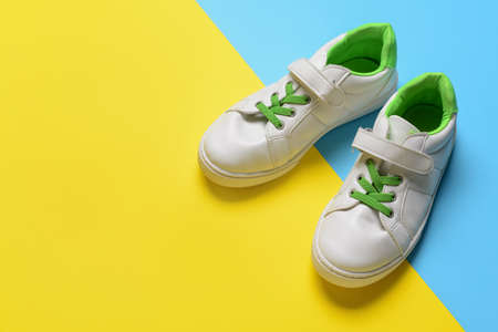 Child's shoes on color backgroundの写真素材