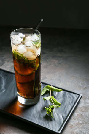 Glass of tasty Cuba Libre cocktail on tableの写真素材