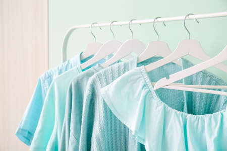 Rack with clothes near color wallの写真素材