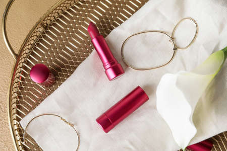 Different lipsticks and bijouterie on tableの写真素材