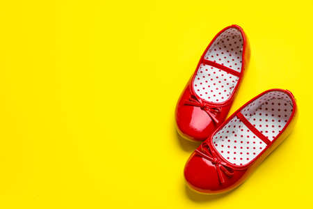 Little girl shoes on color backgroundの写真素材