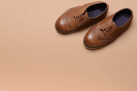 Little boy shoes on color backgroundの写真素材