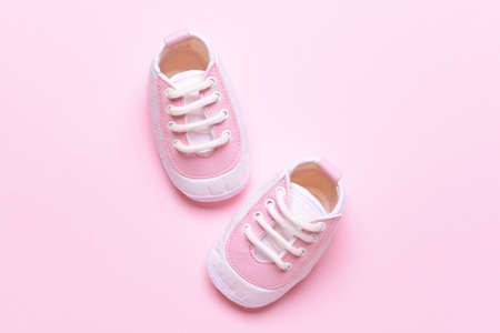 Baby shoes on color background