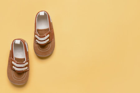 Baby shoes on color backgroundの写真素材