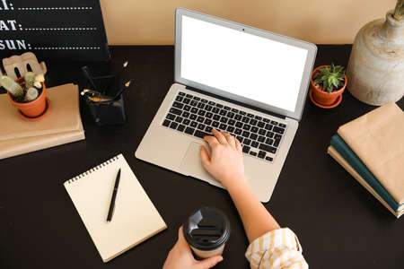 Young woman working on laptop in officeの写真素材