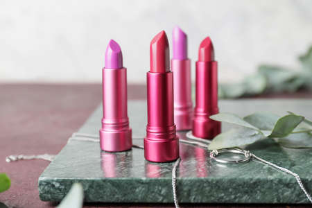Different lipsticks and bijouterie on tableの写真素材