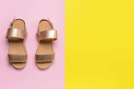 Little girl shoes on color backgroundの写真素材
