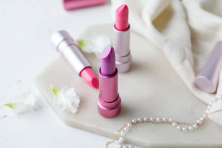 Different lipsticks and bijouterie on tableの写真素材