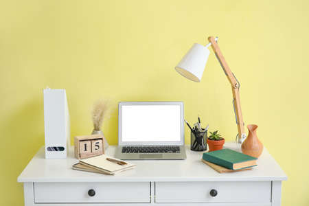 Interior of modern workplace with laptop