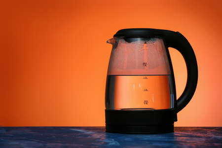 Transparent electric kettle on color backgroundの写真素材