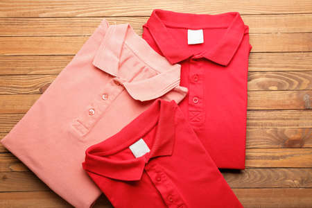 New male shirts on wooden background