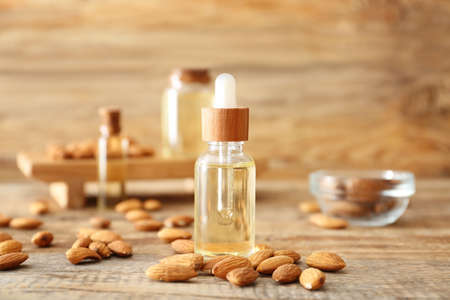 Bottle of almond oil on wooden tableの写真素材