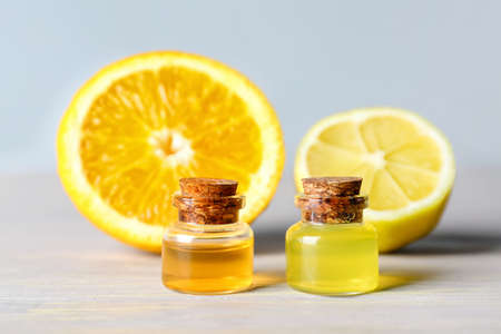 Bottles of lemon essential oil on tableの写真素材