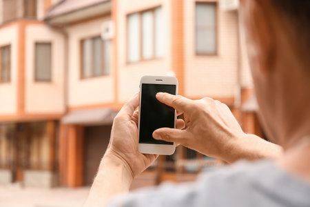 Man using smart phone outdoorsの写真素材