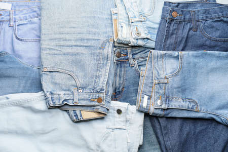 Many stylish jeans as backgroundの写真素材