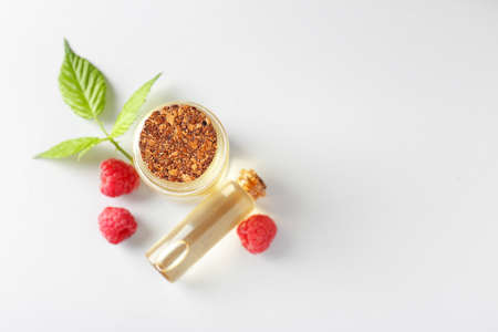 Bottles of raspberry essential oil on light backgroundの写真素材