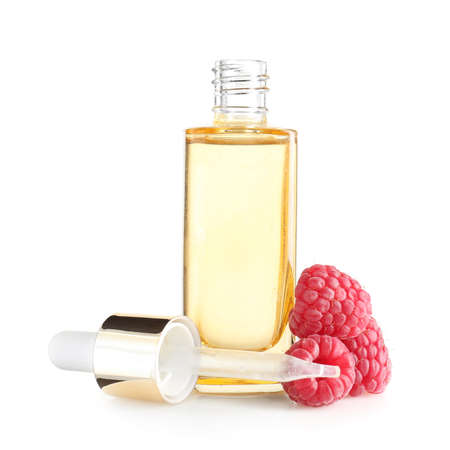 Bottle of raspberry essential oil on white backgroundの写真素材