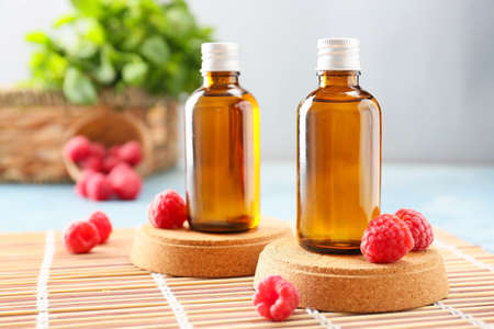 Bottles of raspberry essential oil on tableの写真素材