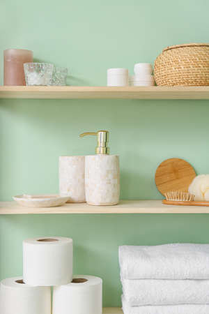 Shelf with bath accessories on color wallの写真素材