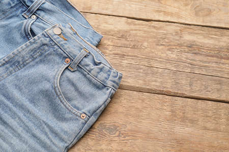 Stylish jeans pants on wooden backgroundの写真素材